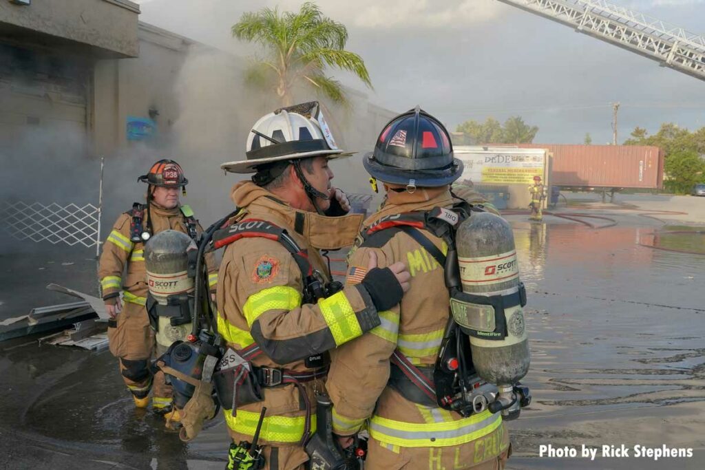 Firefighters at the warehouse fire near a pool of water