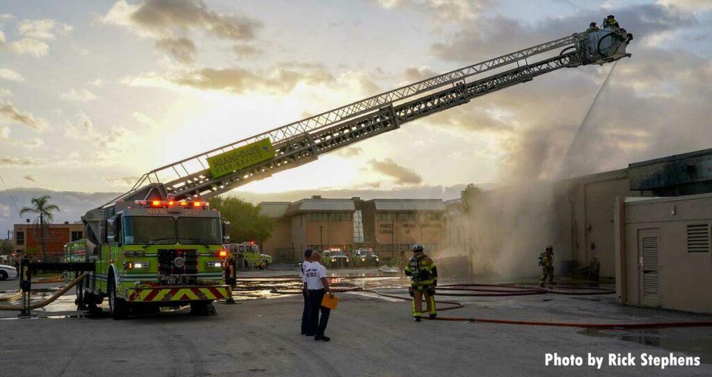 Miami-Dade tower ladder with firefighters in the bucket working the elevated stream