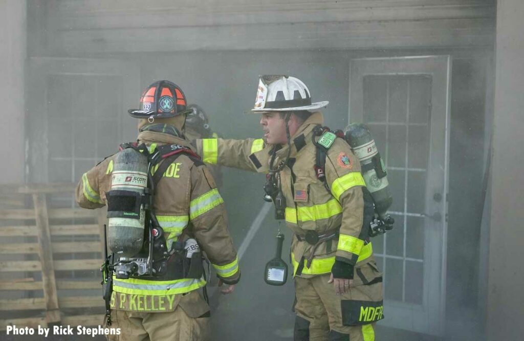 Firefighter consult at the Miami-Dade warehouse fire