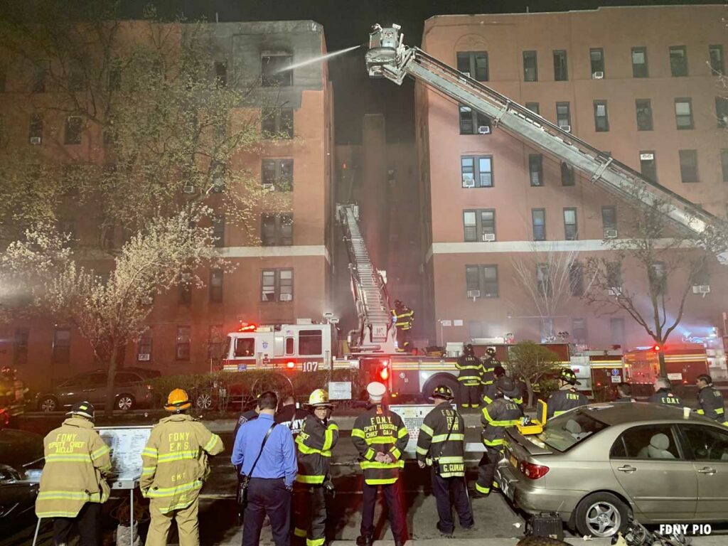 Firefighters at an eight-alarm fire in the New York City borough of Queens