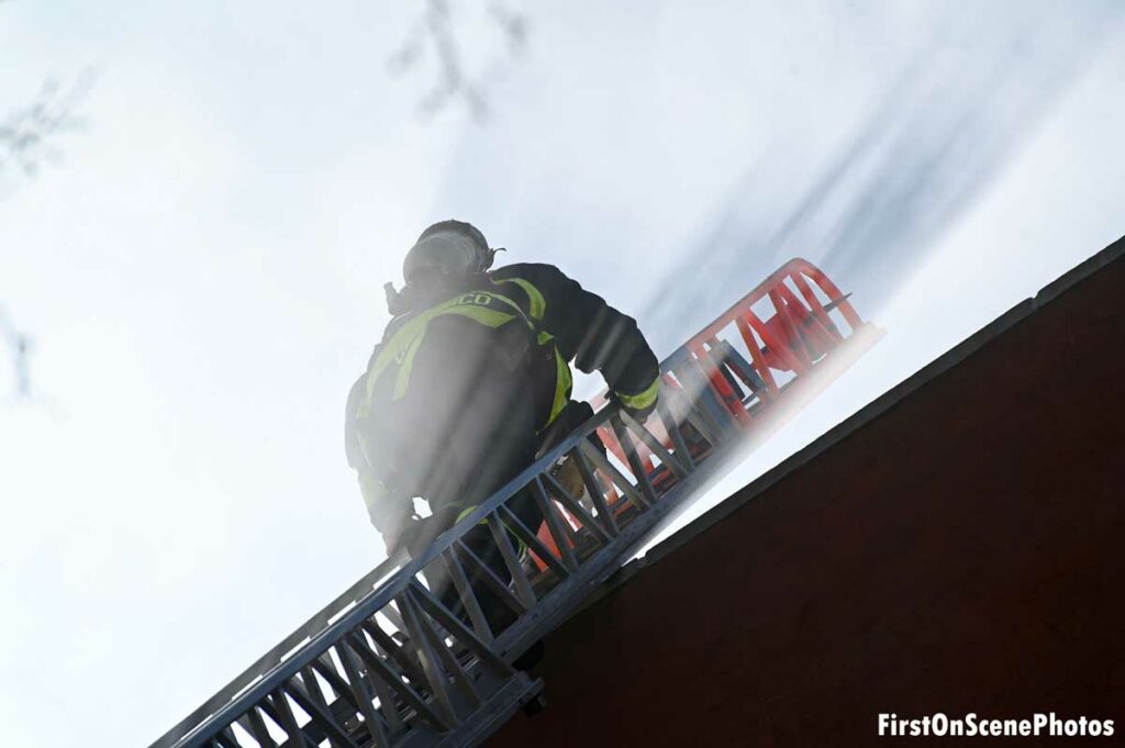 FDNY firefighter on an aerial ladder at a fire in Queens