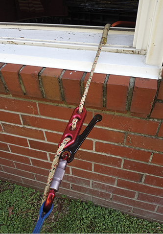 Loaded system 1—the anchor device is loaded (tensioned) using body weight from the firefighter as he rolls out the window.