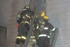 Firefighters removing injured member from building