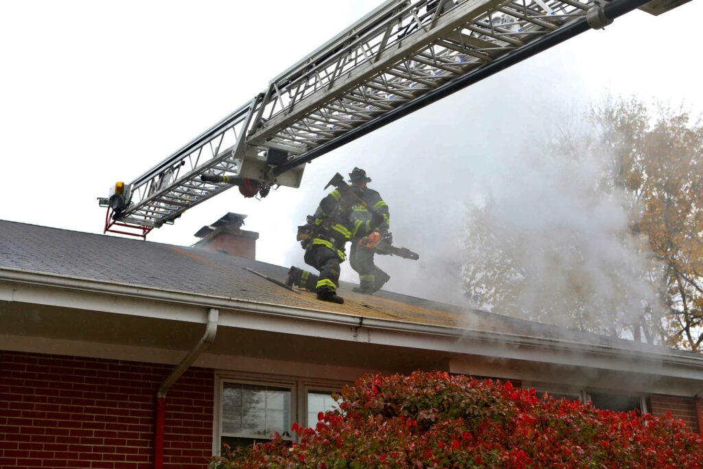 Evanston firefighters work on roof of house fire