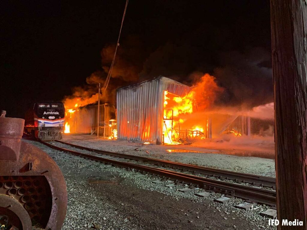 Storage buildings near rail property fully involved in fire in Indianapolis