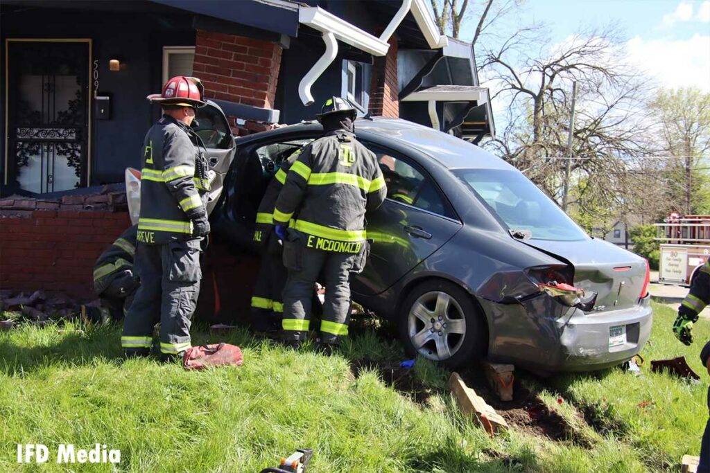 Indianapolis firefighters respond to car into a home