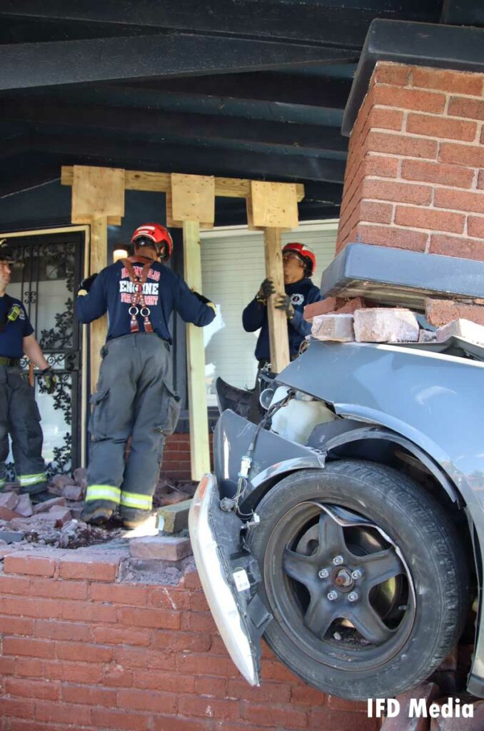 Firefighters use the wooden system to shore up the porch