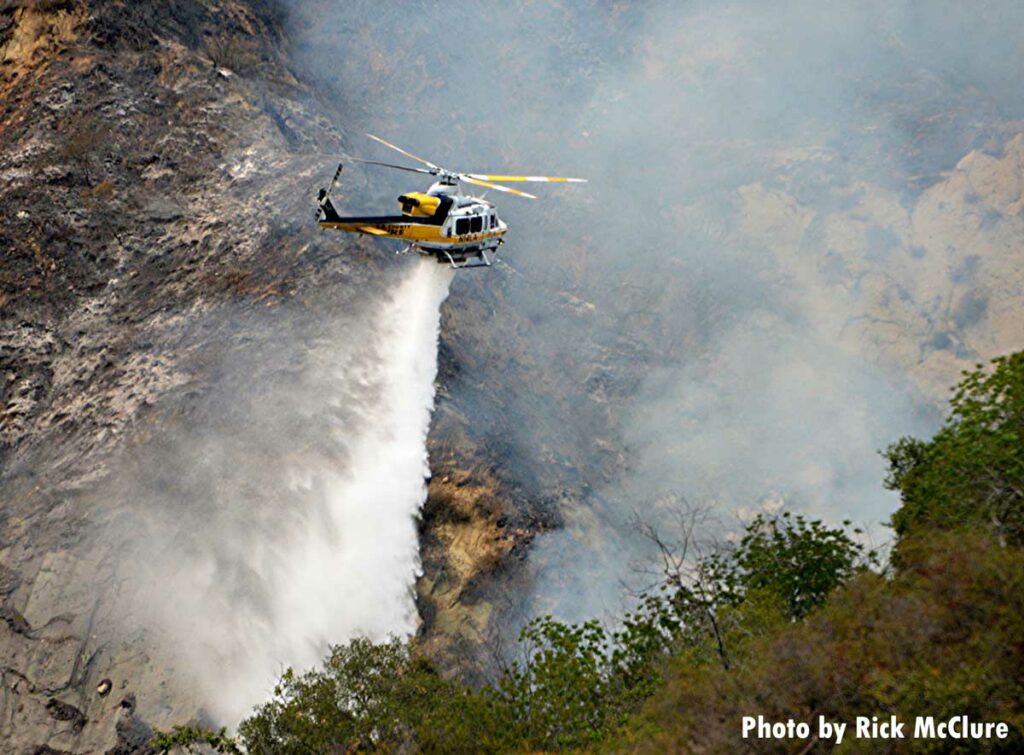 Helicopter makes a drop on the Palisades Fire