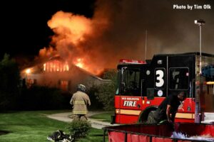 West Burlington fire truck and firefighter at Iowa house fire scene