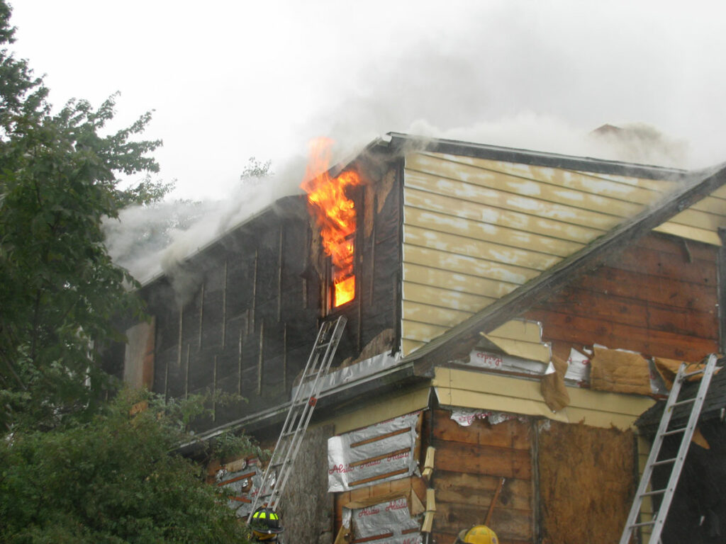 Flames shoot from the window of a building