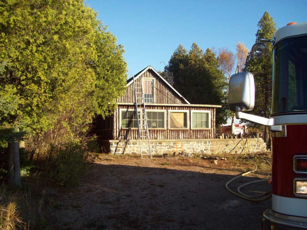 Ground ladder rungs placed above the roofline of a home