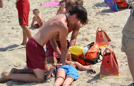 Lifeguards in training train on a rescue dummy