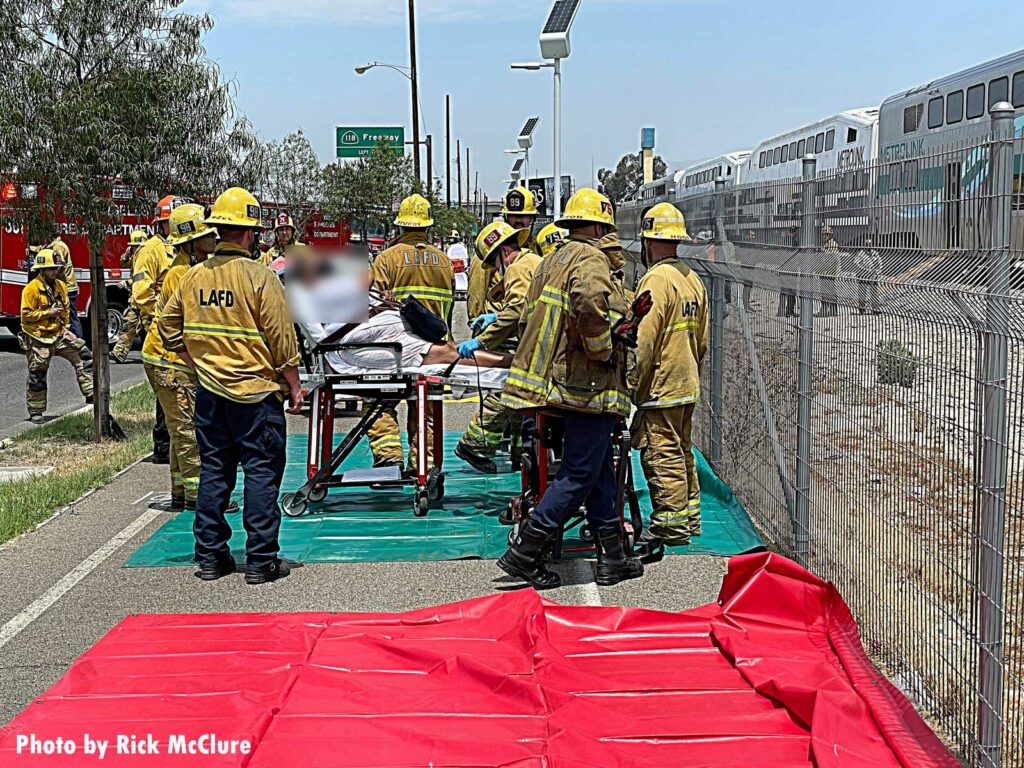 LAFD firefighter load patient onto stretcher