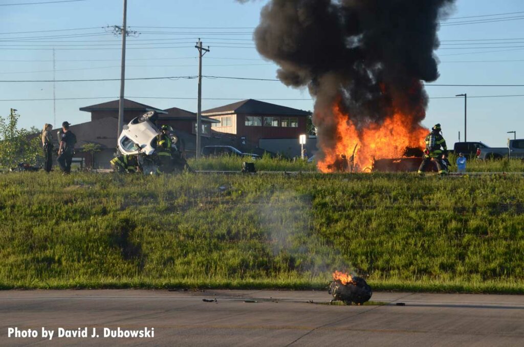 Massive flames and smoke at the scene of a vehicle incident