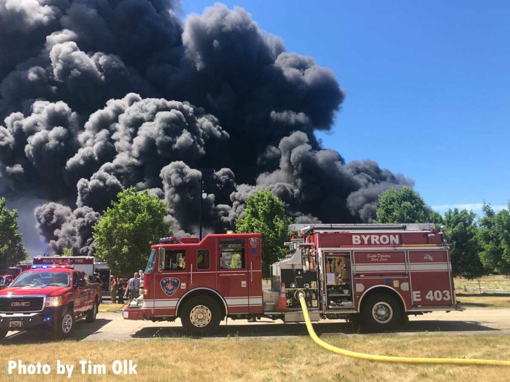 Byron fire truck pumping with clouds of black smoke in background