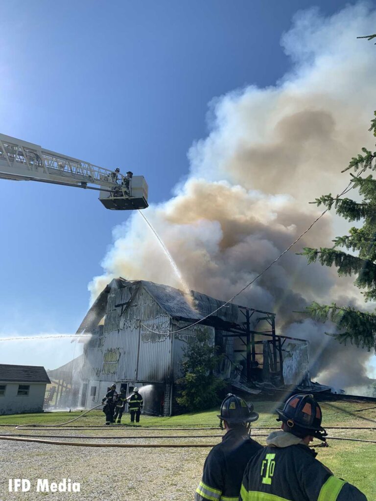 Firefighters and aerial device operating at Indiana barn fire