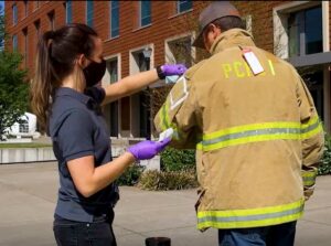 Taking sample of possible chemical exposure from firefighter PPE