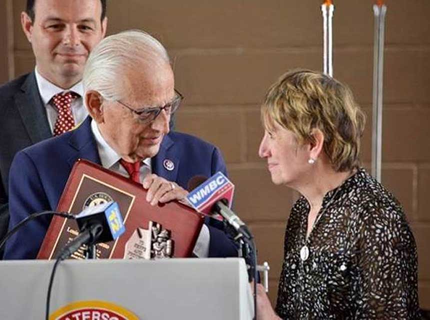 Rep. Pascrell presents a plaque to Marie Imparato, wife of the late Chief Lou Imparato of Passaic City, New Jersey, who played a major role in the crafting of the FIRE Act