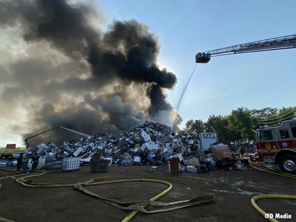 Fire apparatus put elevated master streams on burning scrap metal