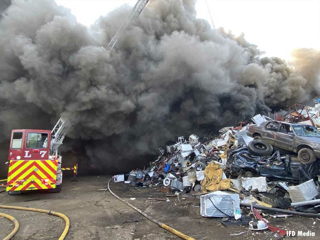 A tiller is enveloped in smoke at a scrap metal fire in Indianapolis