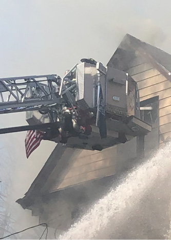 Use a tower ladder stream to knock down a fire in an attic or hydraulically overhaul the roof. If you use it to remove roof sheathing, inform all units on the fireground to maintain a safe distance from the building and be aware of flying debris.