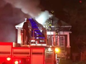 Firefighters on the roof with an aerial