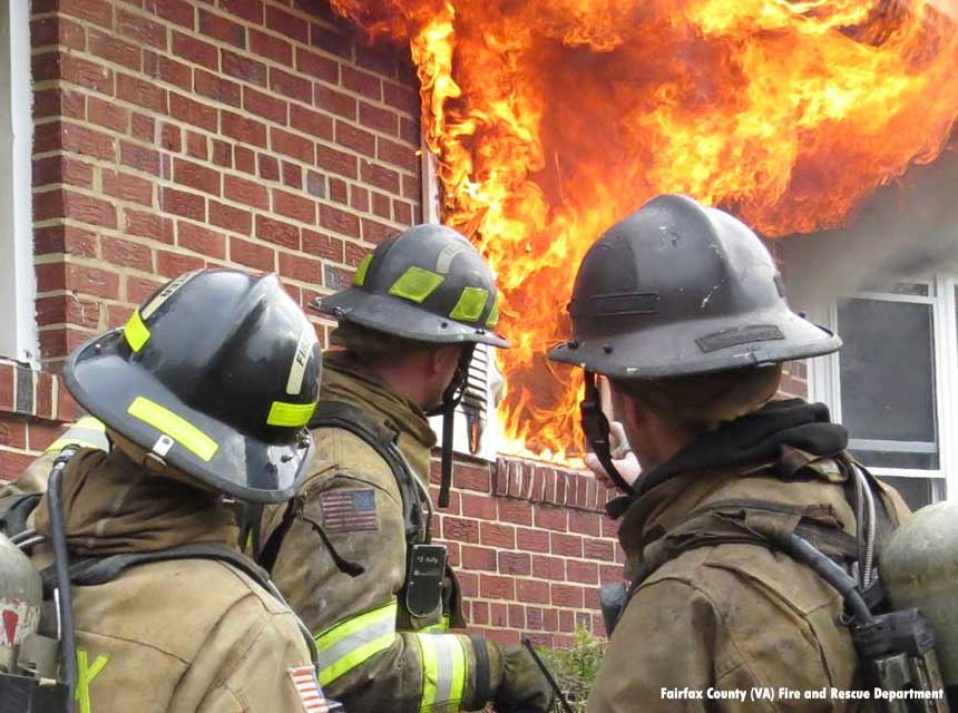 Fairfax County VA firefighters at a structure with fire blowing out the windows