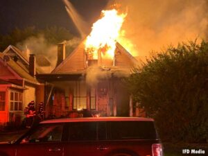 Flames roar from the upper portion of a vacant building in Indianapolis