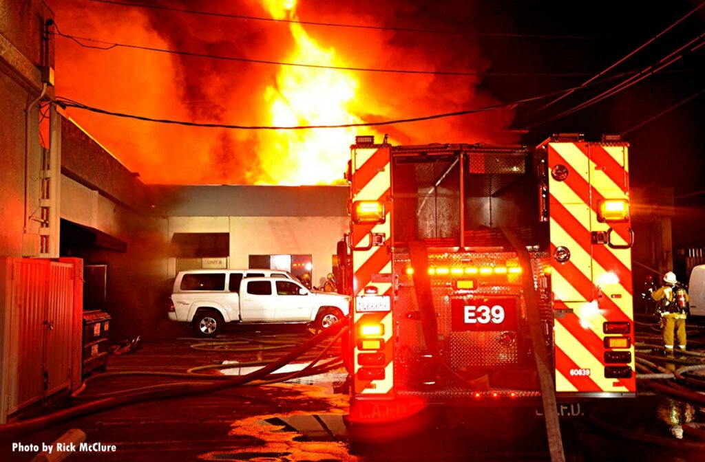 LAFD apparatus with fire emanating from building's roof