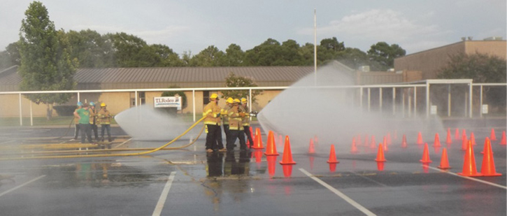 You can incorporate rookie training into the weekly training schedule. Here, rookie members work on hose handling skills with the entire fire department. 