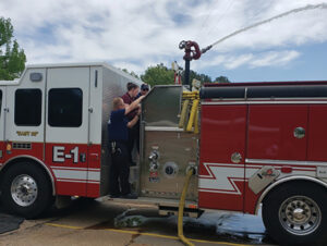 Volunteer firefighter training on deck gun