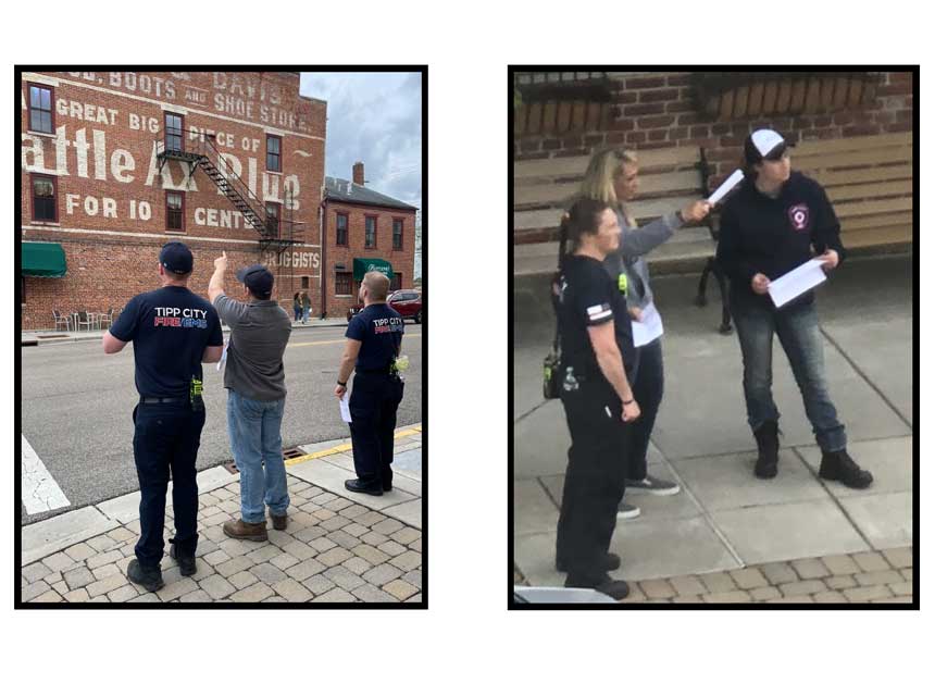 Firefighters examining building exteriors as part of training on building construction challenges