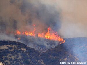 Flames rush up mountain