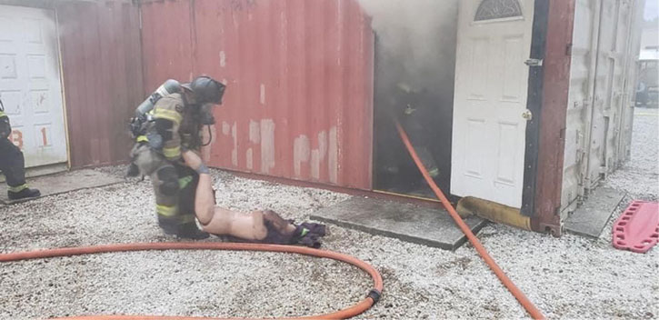 Firefighter drags rescue dummy