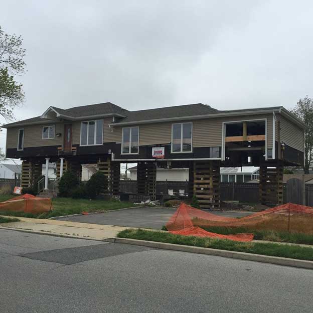 The construction of podium wood-frame homes has surged following federal and local guidelines to ensure homes in designated flood zones are adequately protected from floodwaters.