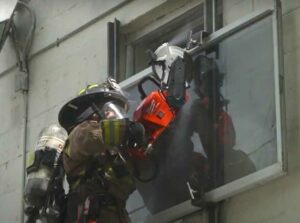 Miami-Dade firefighter practices cutting on glass training prop