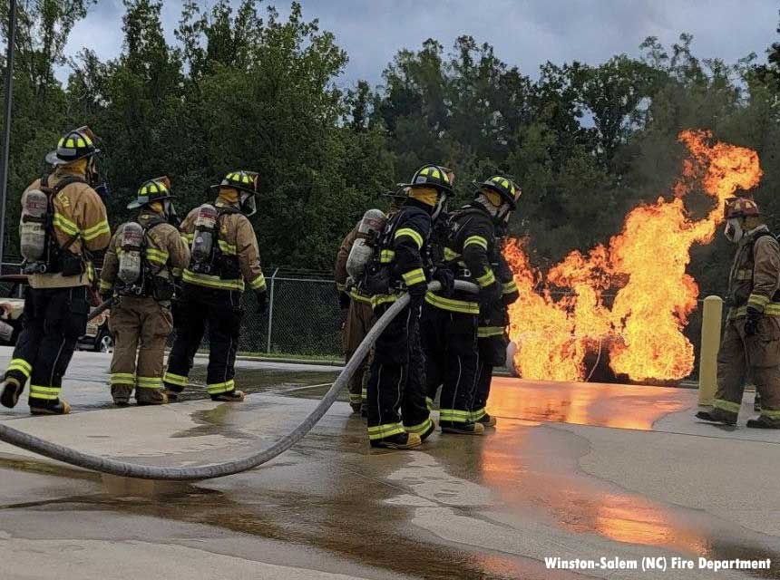 Fire recruits undertake firefighter training on gas prop