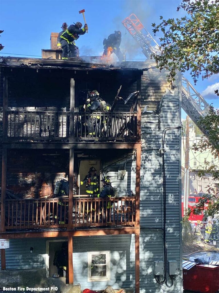 Aerial ladder and Boston firefighters at porch fire