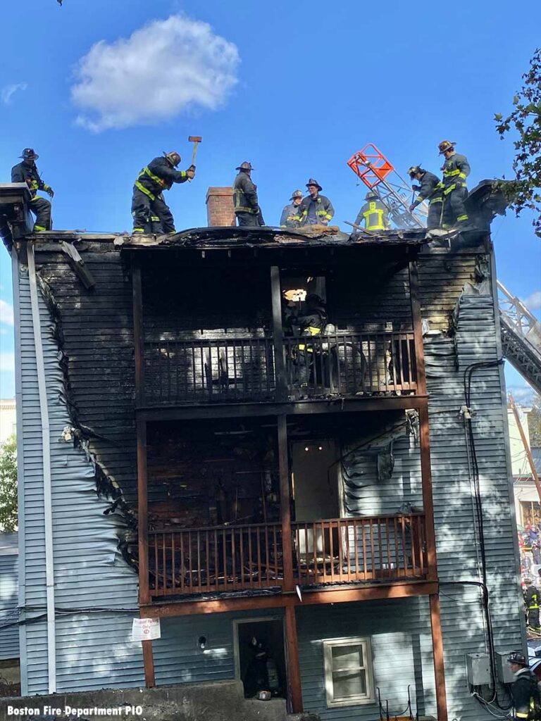 Boston firefighters with axes on roof