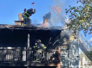 Boston firefighters with fire on roof