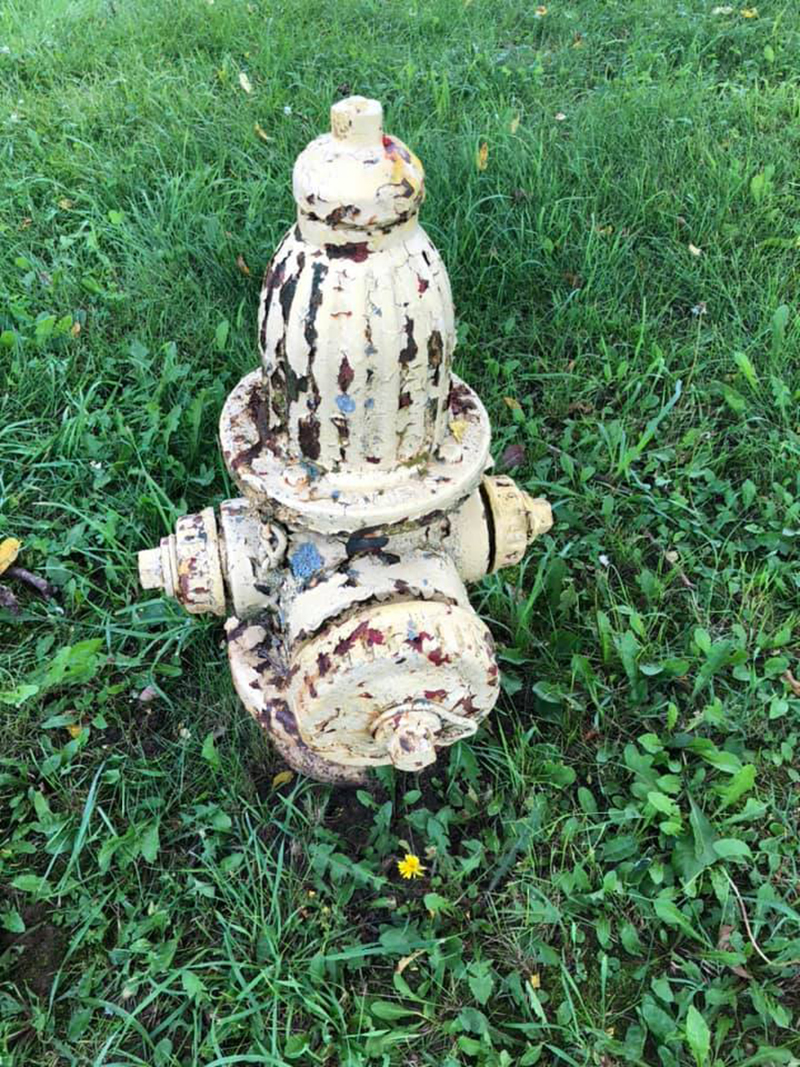 This hydrant had been installed pre-1960 and had multiple layers of paint, rust, and grime.