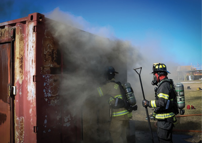 Firefighters performing VES drills with live fire conditions. This photo was taken after the window had been taken out but before the door had been controlled.