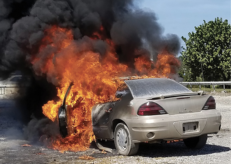 In this training exercise, the fire was set on the driver’s side in the passenger compartment. Notice how it spread to the engine compartment.