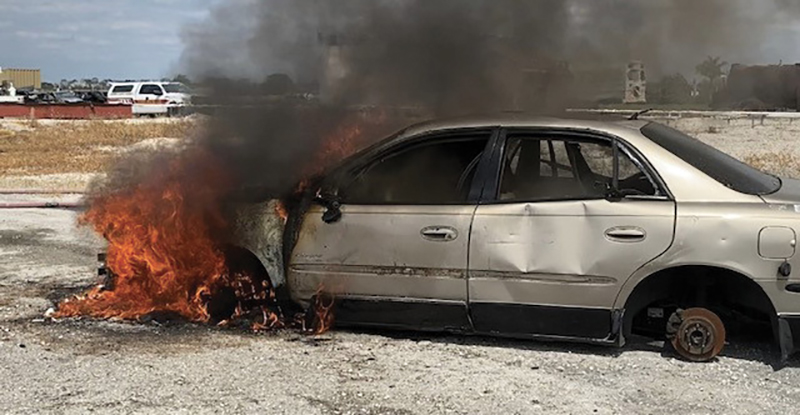 A fully involved engine compartment training exercise in which the fire was started in the engine compartment. In photo 4, note the burn pattern on the driver’s side door. Firefighters pushed back the hood during extinguishment.