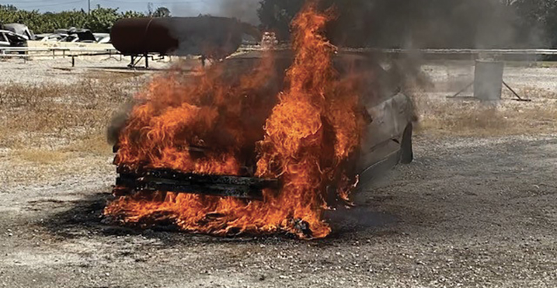 A fully involved engine compartment training exercise in which the fire was started in the engine compartment. In photo 4, note the burn pattern on the driver’s side door. Firefighters pushed back the hood during extinguishment.