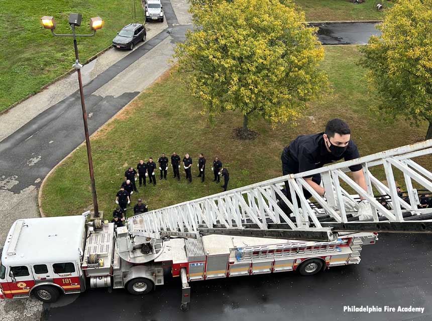 Philadelphia fire recruit climbs an aerial ladder