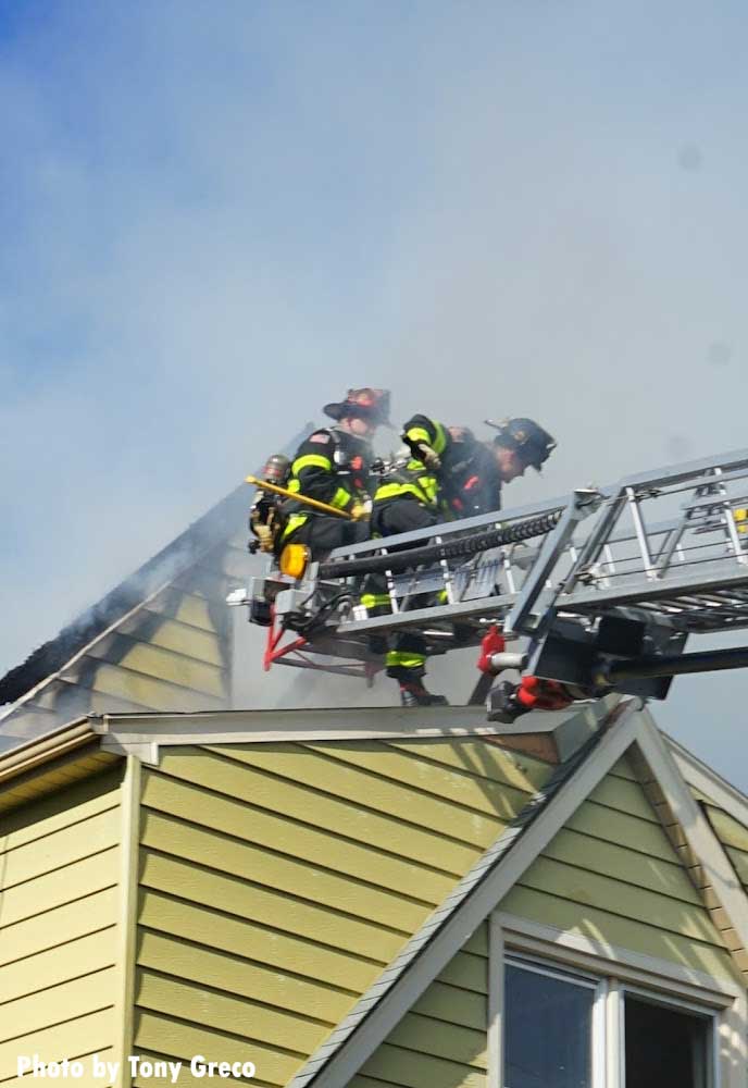 Firefighters on the edge of an aerial ladder