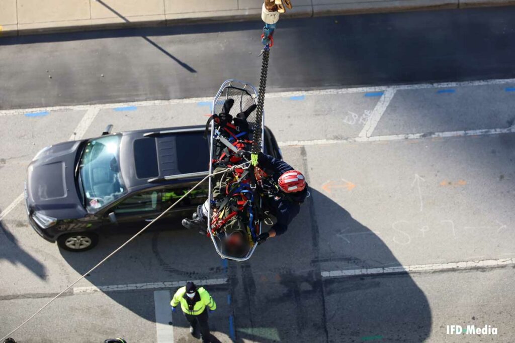 Indianapolis firefighter with patient in stokes basket