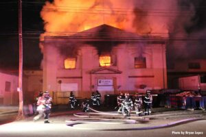 Firefighters with hoselines at four-alarm Long Island fire