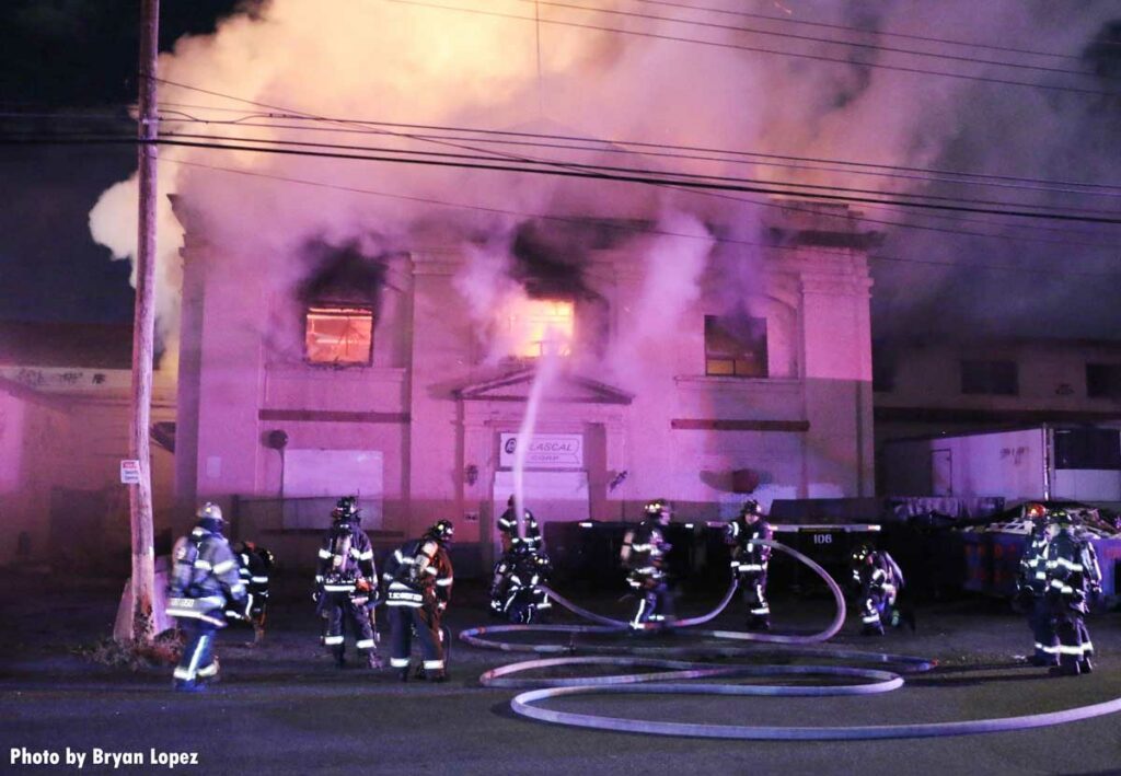 Flames shoot from a warehouse on Long Island